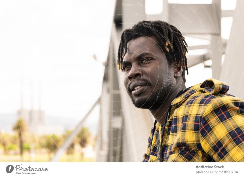 young african man with a structure at background person urban lifestyles black male american portrait guy happy handsome modern trendy cool confident looking