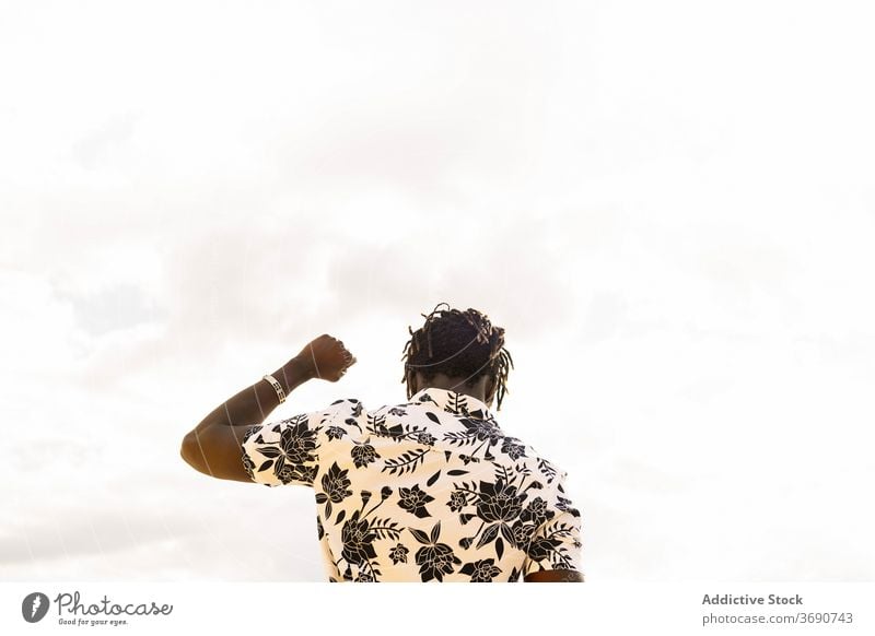 view from the back of a black man with fist raised up person rights protest freedom fight power copy space arm human life matter revolution gesture victory