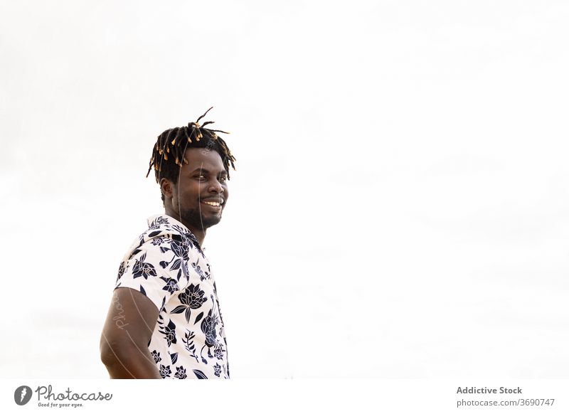 stylish young black man with flower shirt smiling person male happy copy space smile african portrait isolated guy handsome looking confident american standing