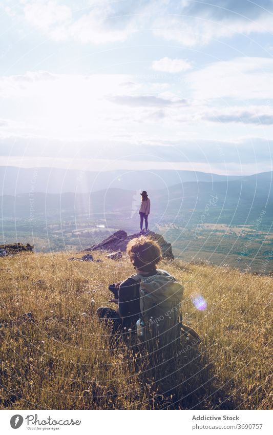 Couple of travelers on hill in mountains couple vacation admire tranquil relax highland majestic holiday landscape autumn nature together fall journey trip