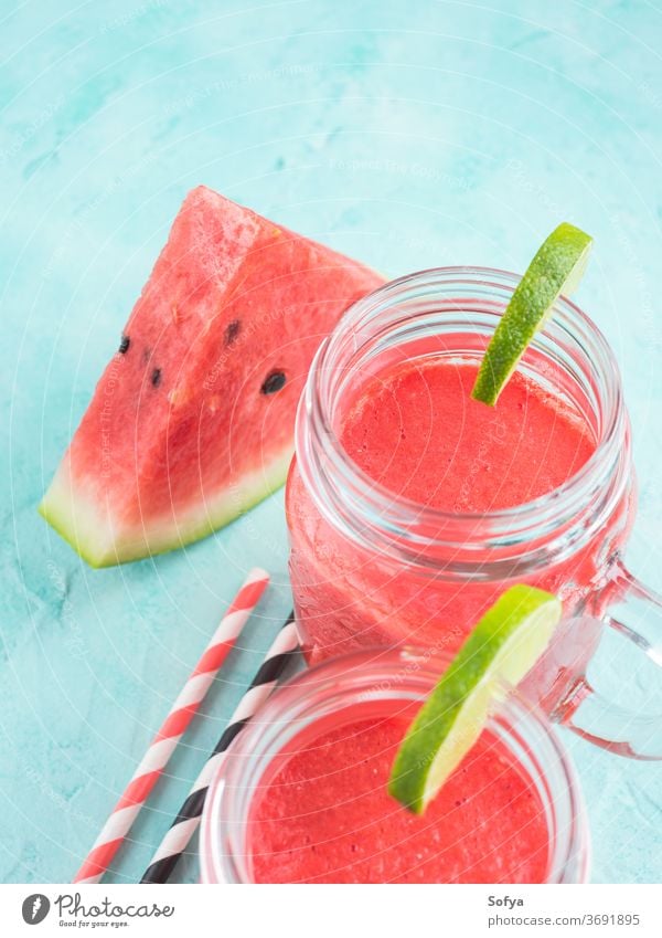 Watermelon smoothie with lime and mint watermelon summer drink green blue turquoise red beverage juice cocktail fresh cold straw berry mason jar glass citrus