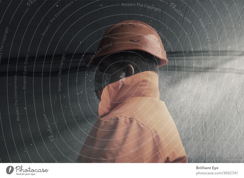 Side view of a railway worker with orange work clothes and protective mask in the tunnel Caucasian Construction conceit Dirty Dramatic Engineering Grunge