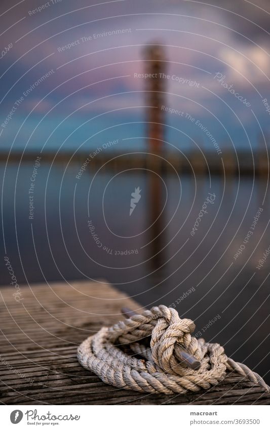 Gauge tower in the evening gauge tower Evening sun Sky sunset Rope Strick rope investor jetty Landing stage berth Mooring place Harbour home port wooden walkway