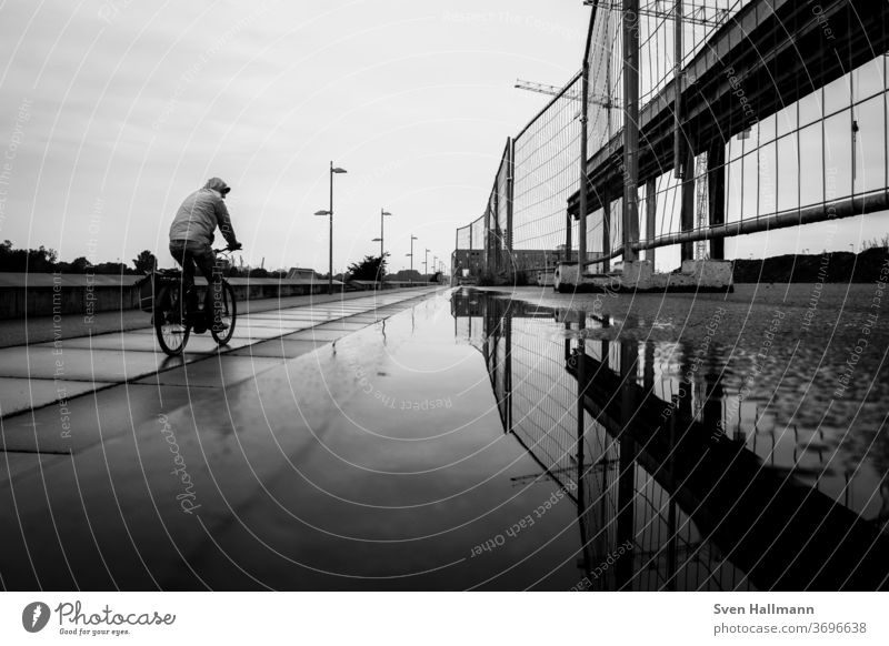 Cyclists next to the site fence Bicycle Cycling Transport Street Sports Movement Leisure and hobbies Healthy Mobility cyclists Road traffic City urban