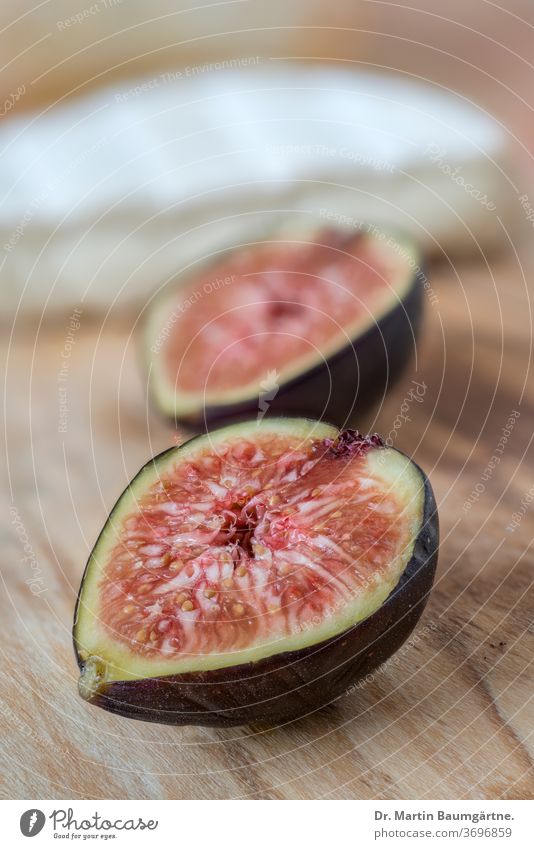 Figs and Italian soft cheese (Paglietta) fruit halved Sliced Cheese olive wood Blur white cheese from Piedmont