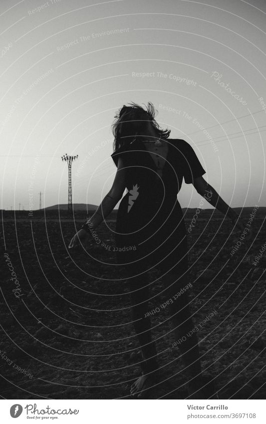 Young woman dancing in the fields landscape freedom woman water adult alive yoga air arm close up alternative portrait breathe standing face shirt spiritual