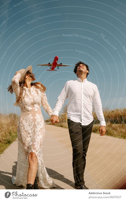 Newlywed couple enjoying romantic journey newlywed travel airplane stroll relationship love honeymoon fly happy cheerful amorous walk fondness together married