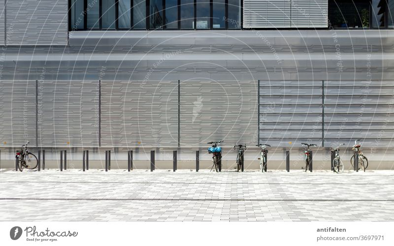 ready for departure Cycling Bicycle Bicycle rack Stand house wall Architecture Parking Means of transport Deserted Exterior shot Colour photo Transport Day Town