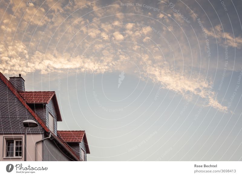 Bright evening clouds over gabled roof Clouds evening sky House (Residential Structure) Roof pediment Window Architecture Facade built Sky Exterior shot