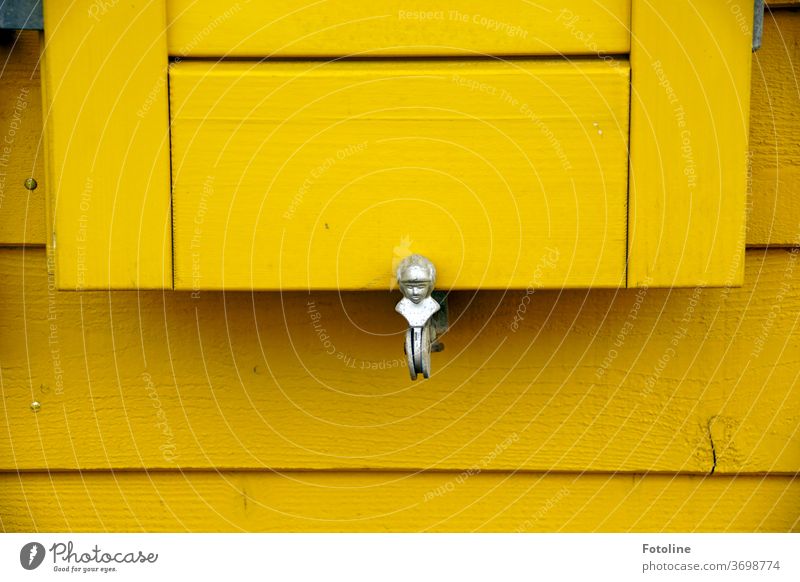 A slightly different mounting bracket for shutters. They are located at the colourful little houses on the dune of Helgoland. Bracket wood Metal Deserted