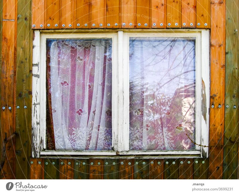 Window on the construction trailer Wooden wall Site trailer Close-up Reflection Curtain