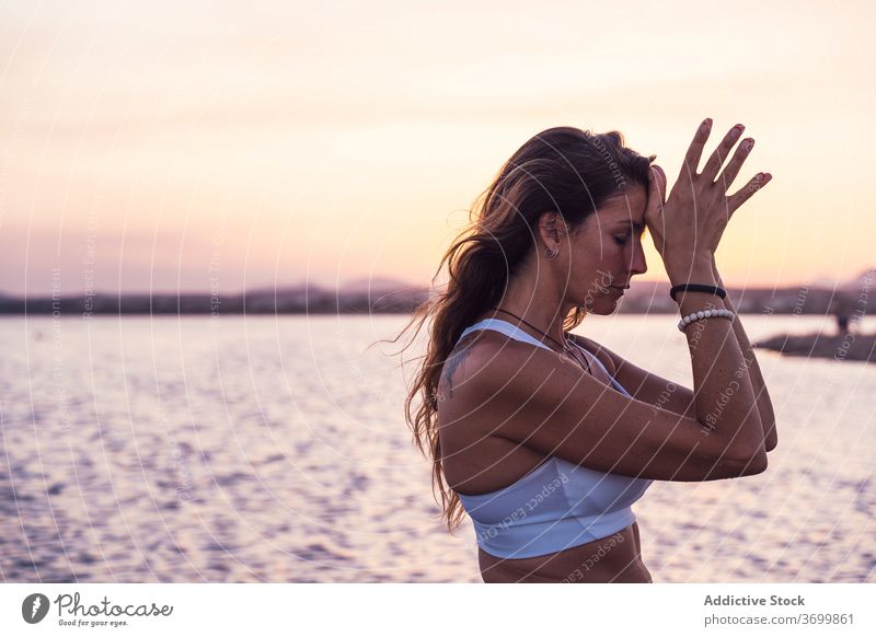 Focused woman meditating near river meditate lake sunset yoga harmony zen nature mudra peaceful practice pose focus balance calm tranquil soul equilibrium relax