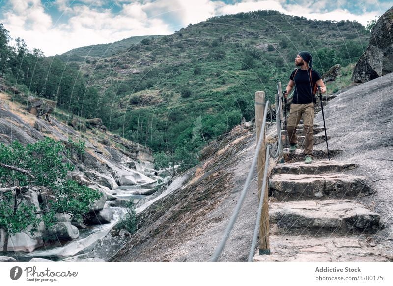 Male hiker in mountainous area man admire highland trekking pole adventure scenery wanderlust male majestic tourism travel nature holiday walk tourist vacation