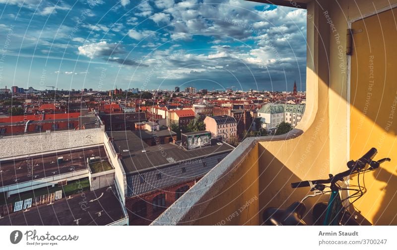 The sea of houses in Berlin Kreuzberg seen from a balcony with a dramatic sky bicycle landscape urban city town skyscraper wide far architecture skyline