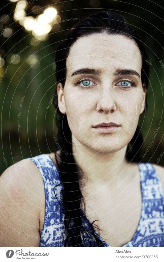 Close portrait of a freckled woman with wet hair in a lake in front of reeds Delicate Light Athletic Feminine empathy Emotions emotionally