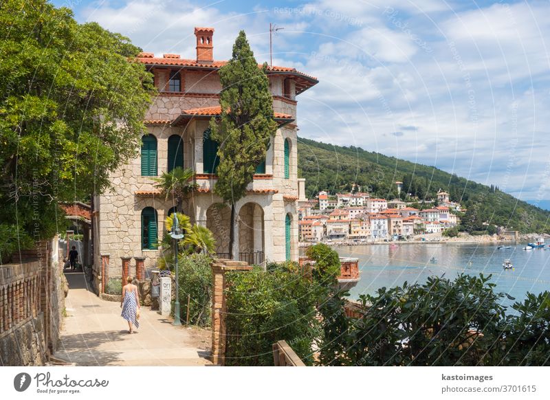 Tourists walking along the Adriatic coast and relaxing on holiday in Moscenicka Draga, Istria, Croatia. moscenicka draga Tourism already Coast seascape