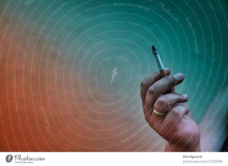 Smoking? - Only with filter! Filter play with orange and green gradient filter around a filter cigarette. Ring Cigarette Wedding band by hand Fingers Orange