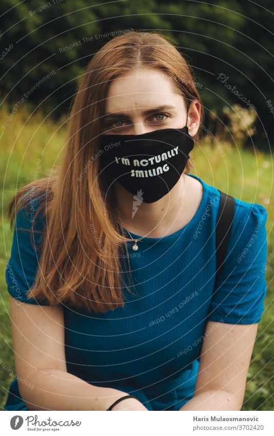 woman with mask outdoors with text i am actually smiling casual concept corona mask corona virus coronavirus covid-19 culture education everyday healthy holding