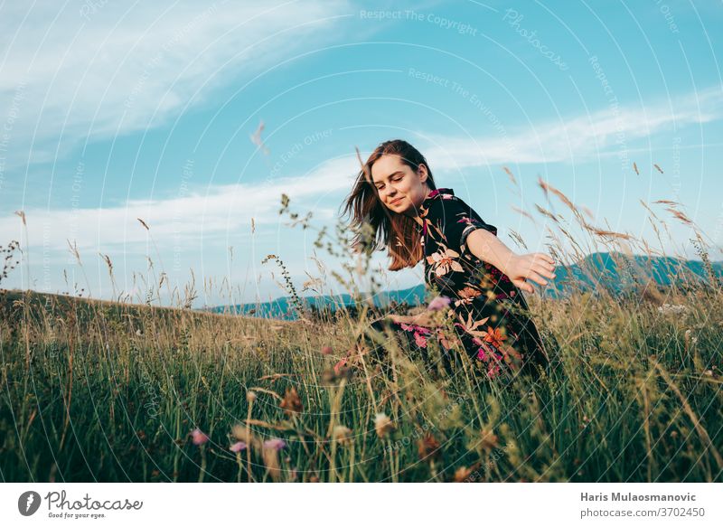 Woman enjoying nature on summer day adult beautiful beauty blonde blu sky caucasian dress face fashion female field flower dress freedom girl grass field hair