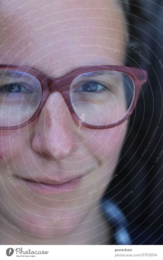 Close-up of the face of a friendly smiling woman with glasses Face Woman smile kind cheerful Adults portrait Looking Feminine natural Authentic brunette