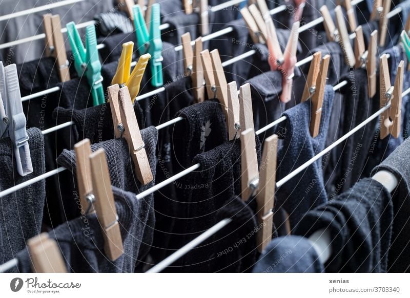 Dark socks - black, grey and blue stockings hang with clothes pegs to dry on the clothes horse Stockings Laundry Holder clothespin Cotheshorse Black Gray Blue