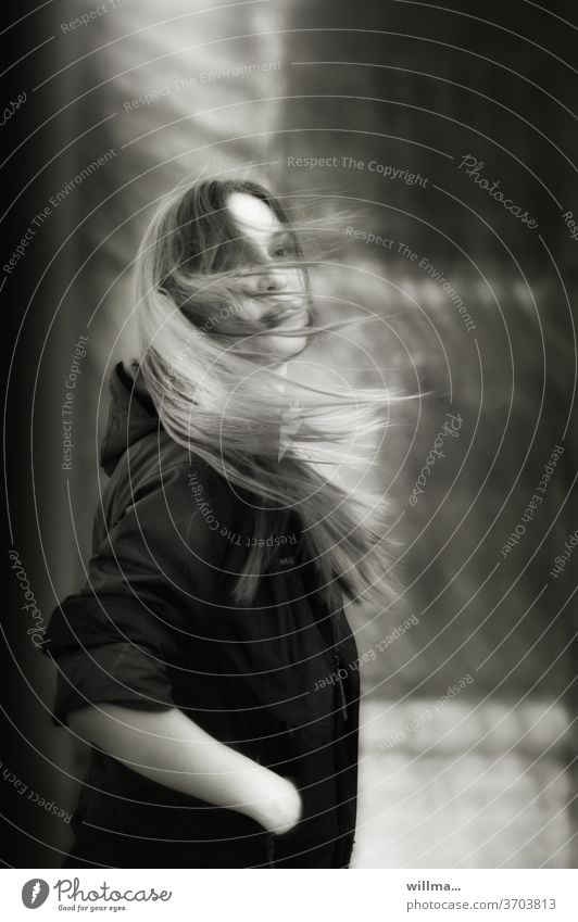 Girl with long hair in the wind Young woman Long-haired hands in the pockets windy Wait Wind Woman Youth (Young adults) Human being pretty Attractive Stand