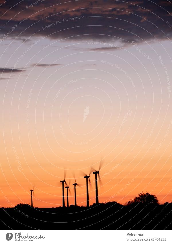 Wind turbines in the evening light wind power Wind energy plant Pinwheel windmills Energy Alternative alternative energy Alternative Energies renewable