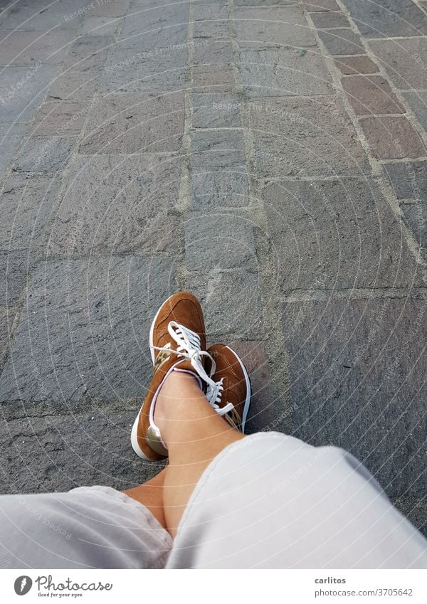 Feet on the ground Human being Legs foot Footwear pavement downtown Old town Break Sit Woman Street High heels