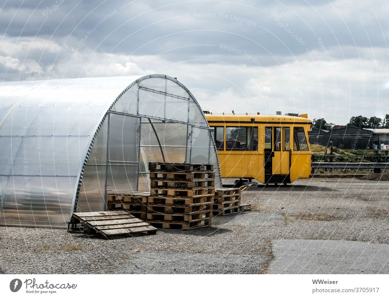 Glass house, pallets and parked tram in Bremen-Überseestadt Tram Palett glass house Greenhouse Empty turned off European port Weser overseas city Territory