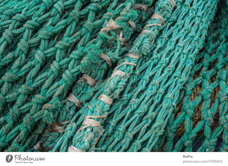 Detail of a trawl net on a pier. Fishing net Net fishnet Fisherman fishing weave craft tangle Rope rope little story scam Lake Ocean High sea Deep-sea fishermen