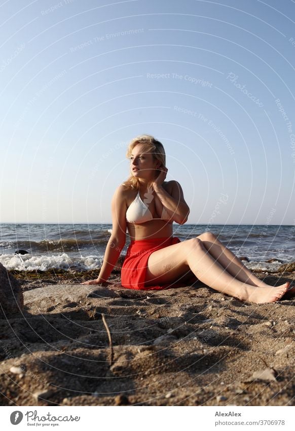 Portrait of a young blonde woman in front of the Baltic Sea Young woman Woman girl 18-20 years Blonde Slim already Curly sensual natural green eyes long hairs