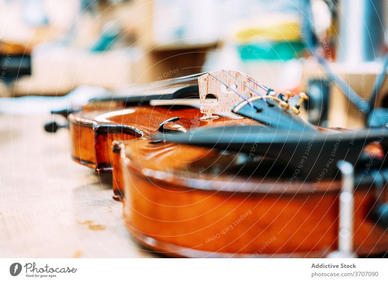 Shiny violin on table in shop store workshop modern production shiny instrument bright melody sound contemporary design creative art style retail elegant simple