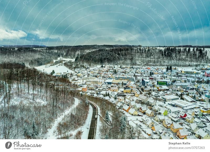 Albstadt, snow city at the Schwaebische Alb of germany in white powdered winter landscape with cloudy blue sky. schwaebische alb albstadt living drone vintage