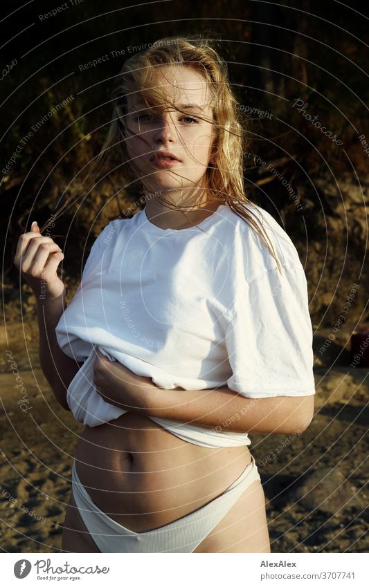 Portrait of a young blonde woman in front of the Baltic Sea Young woman Woman girl 18-20 years Blonde Slim already Curly sensual natural green eyes long hairs