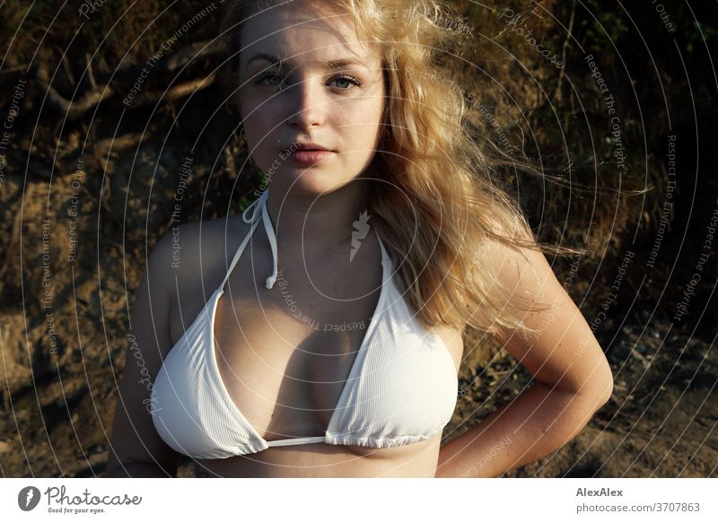 Portrait of a young, blonde woman in front of the cliffs at the Baltic Sea Young woman Woman girl 18-20 years Blonde Slim already Curly sensual natural