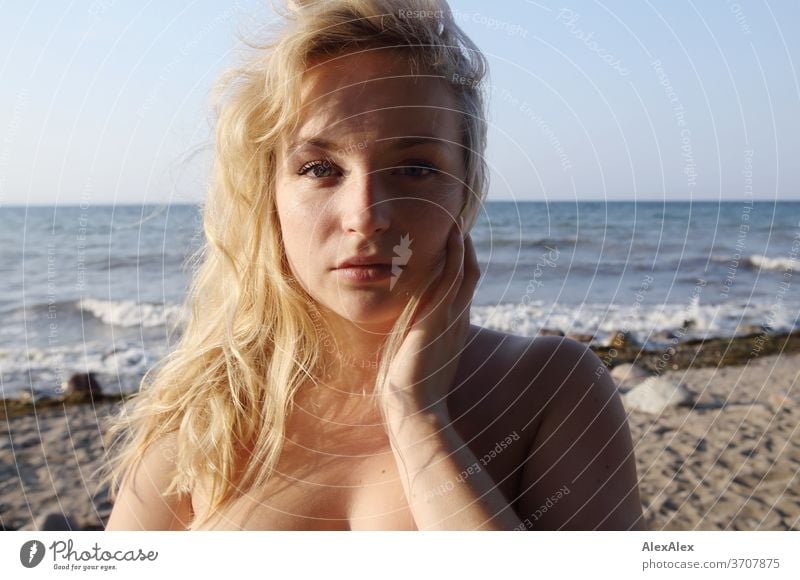 Portrait of a young blonde woman in front of the Baltic Sea Young woman Woman girl 18-20 years Blonde Slim already Curly sensual natural green eyes long hairs