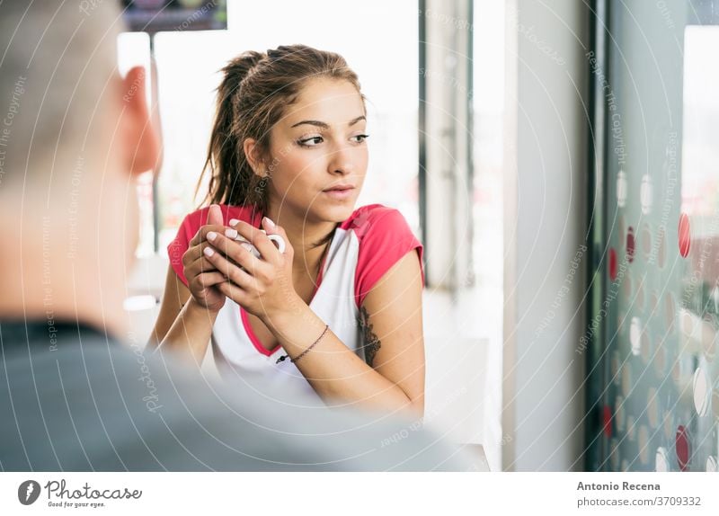 Young beauty woman in bar drinking coffee window behind sexy attractive one person happy cheerful alone serious serene 20s waiting 20-25 years pretty glass