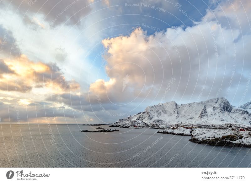 Clouds illuminated by the sunrise over Reine on the Lofoten Lofotes Norway Island Ocean Sky Wide angle Sunrise Horizon Rock Water Air Winter vacation voyage