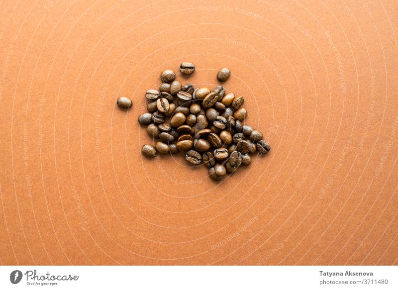 Coffee beans on brown background close up coffee roasted dark natural food closeup texture close-up color macro ingredient roasting textured heap abstract