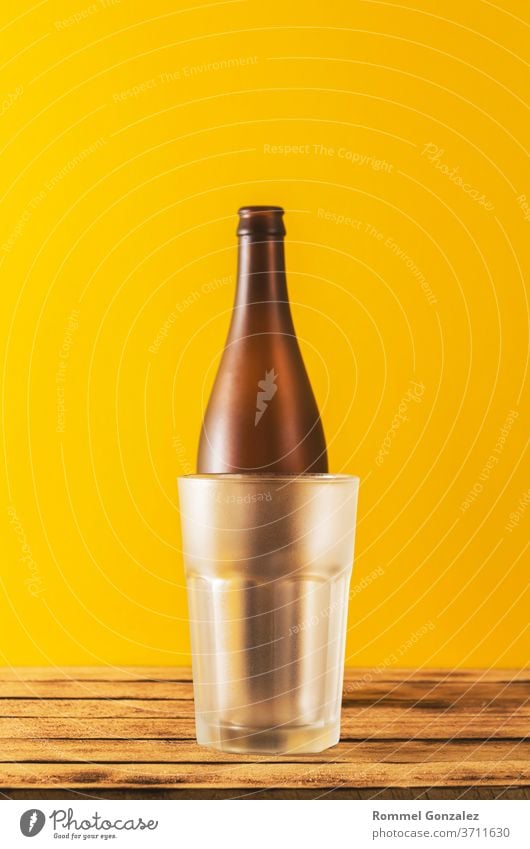 Empty beer glass, bottle beer on a wooden background and yellow, selective focus. beer bottles club october fest bavarian festival munich shot oktoberfest