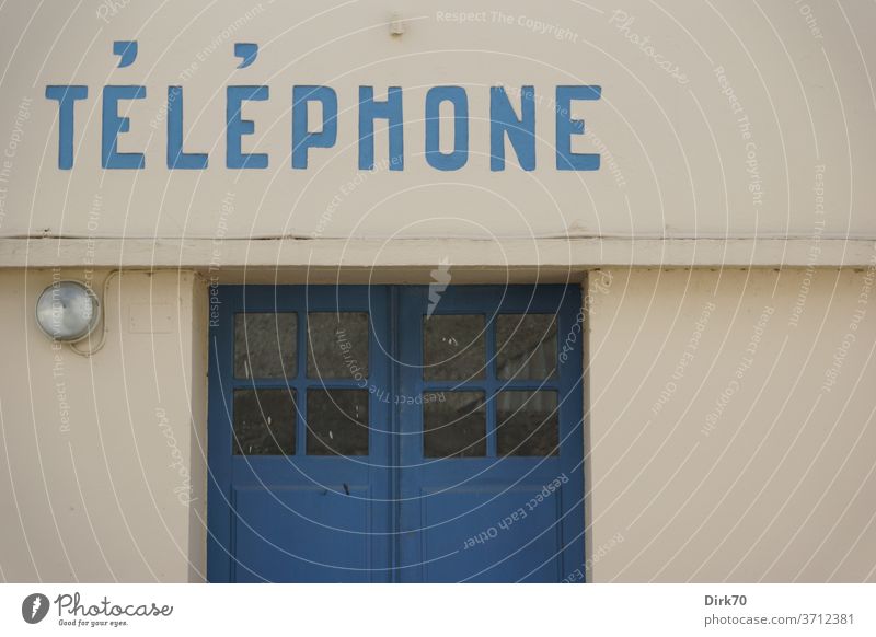 Public telephone in Brittany Telephone communication Phone box public telephone door Lamp Facade built House (Residential Structure) writing Telecommunications