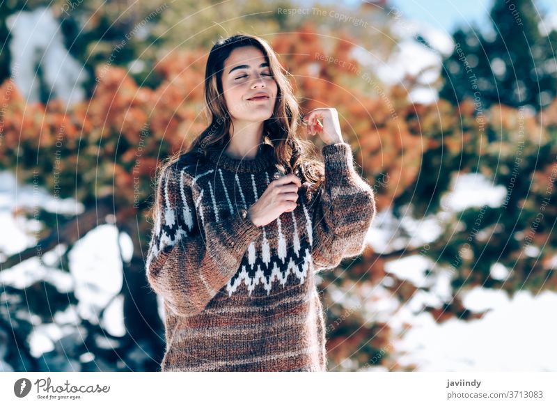 Young woman enjoying the snowy mountains in winter caucasian sweater nature active fashion young beautiful cute beauty girl happiness outdoor smile european