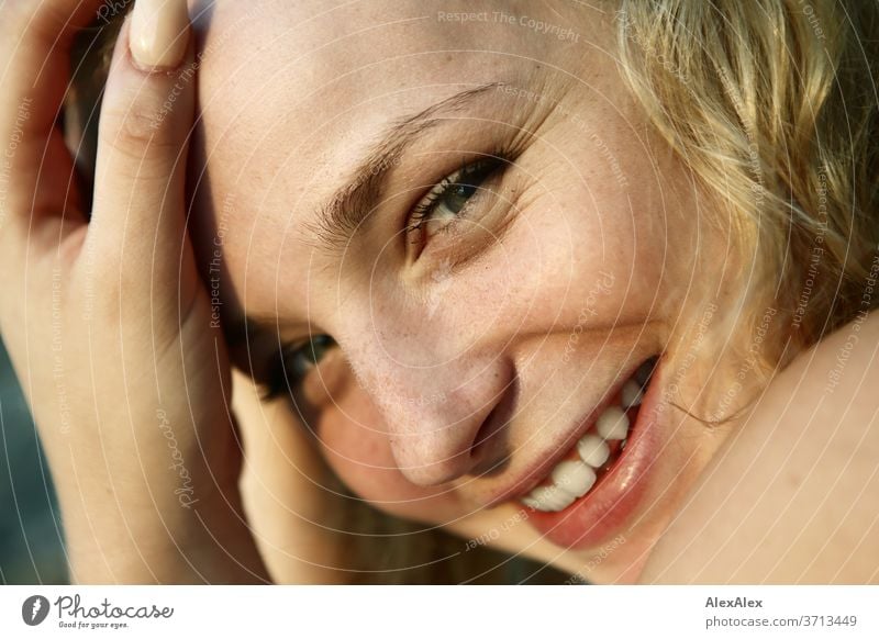 Portrait of a young blonde woman in front of the Baltic Sea Young woman Woman girl 18-20 years Blonde Slim already Curly sensual natural green eyes long hairs