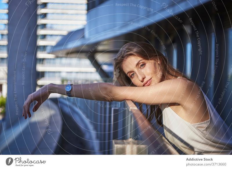 Thoughtful young woman standing near modern building thoughtful pensive lonely think urban sad female contemporary contemplate lifestyle dream alone serious