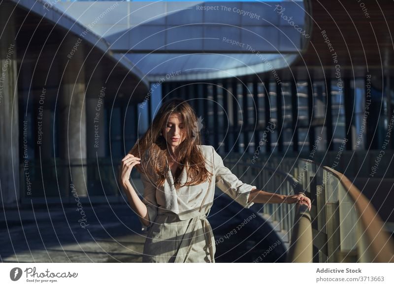 Thoughtful young woman standing near modern building thoughtful pensive lonely think urban sad female contemporary contemplate lifestyle dream alone serious