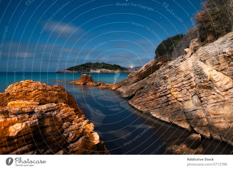 Seascape with rocky shore in evening seaside landscape starry night sky calm water scenery san telmo mallorca spain rough ocean amazing coast tranquil scenic