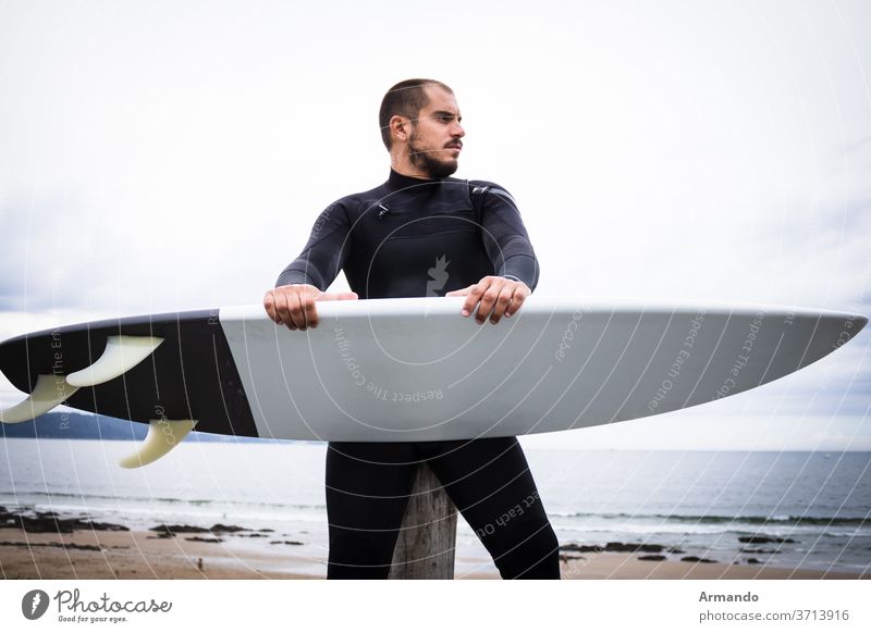 Surfboard Surfer, Man in Mask and Wetsuit on the Beach recreation surfing male sport surfer action athlete extreme hobby ride risky wave weather person