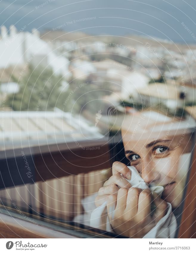 Portrait of a pretty brunette woman with blue eyes, looking at camera, photographed through glass. sexy lip portrait at home stay at home model bedroom glamour