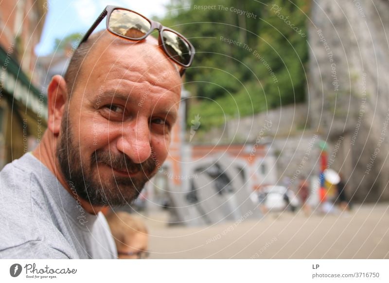 Man with beard and glasses on his head smiling at the camera Beard bearded real people Adults Portrait photograph Human being Guy Cool (slang) Lifestyle Style