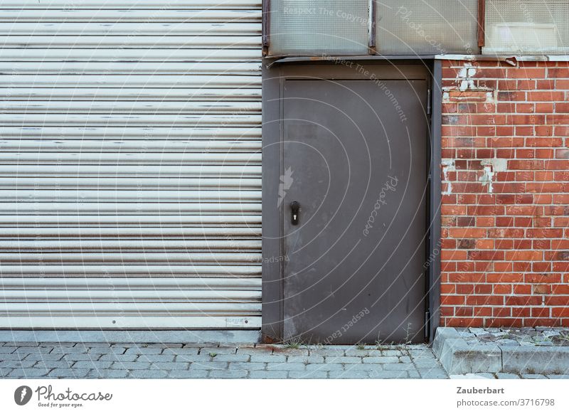 Steel door, gate, brick wall and blind windows of an old factory steel door Factory Goal slats Wall (building) Bricks Brick red Gray Slice Pane areas geometric